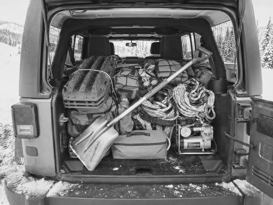Outdoor vehicle trunk packed with recovery equipment.
