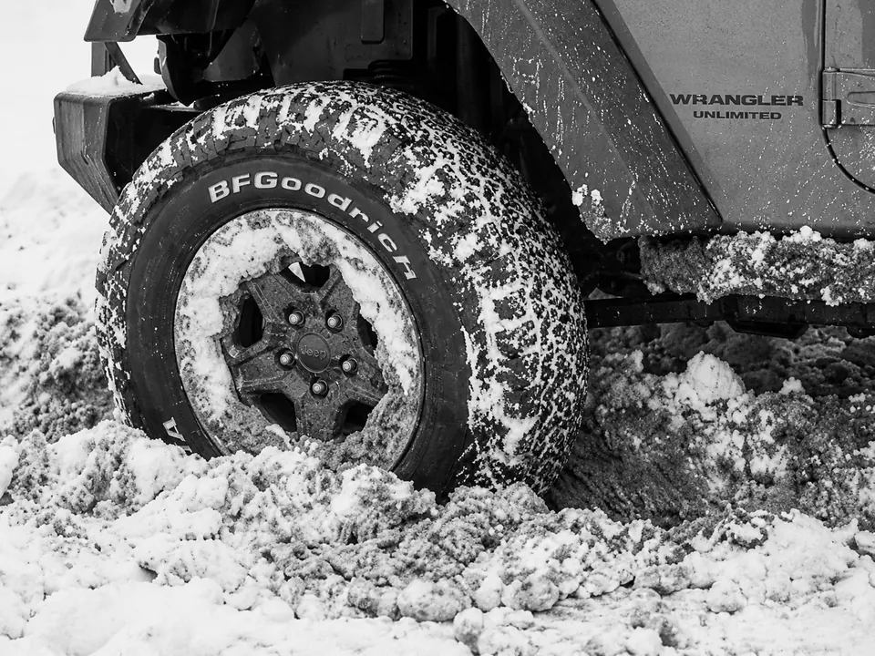 Vehicle tire stuck in snow and mud.