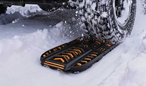 Ways Out placed under a tire for traction recovery in snow.